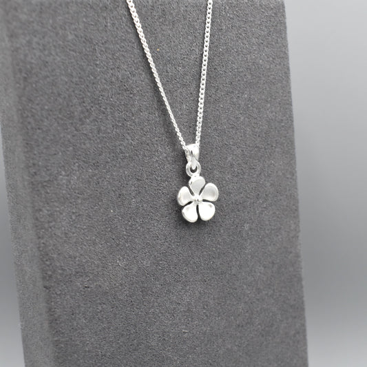 A matt textured silver flower pendant on silver chain