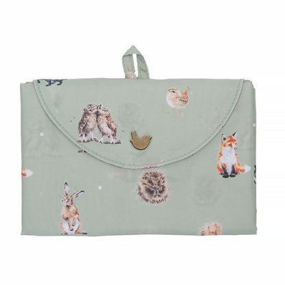 Folded green shopping tote bag with woodland animal repeat print