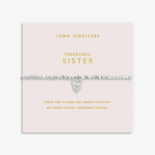 Silver bracelet with two interlinked hearts in silver and CZ, with a sentiment that reads 'Treasured Sister'