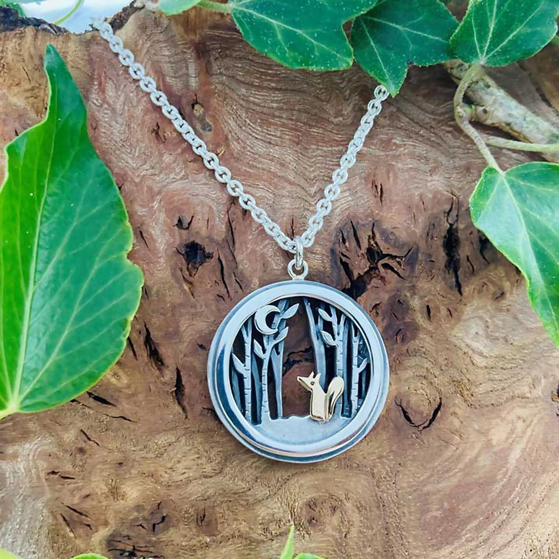 A round pendant with gold fox in a silver forest under a crescent moon lifestyle