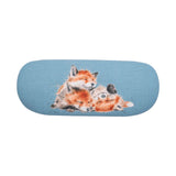 Light blue glasses case back with design of three cuddling fox cubs