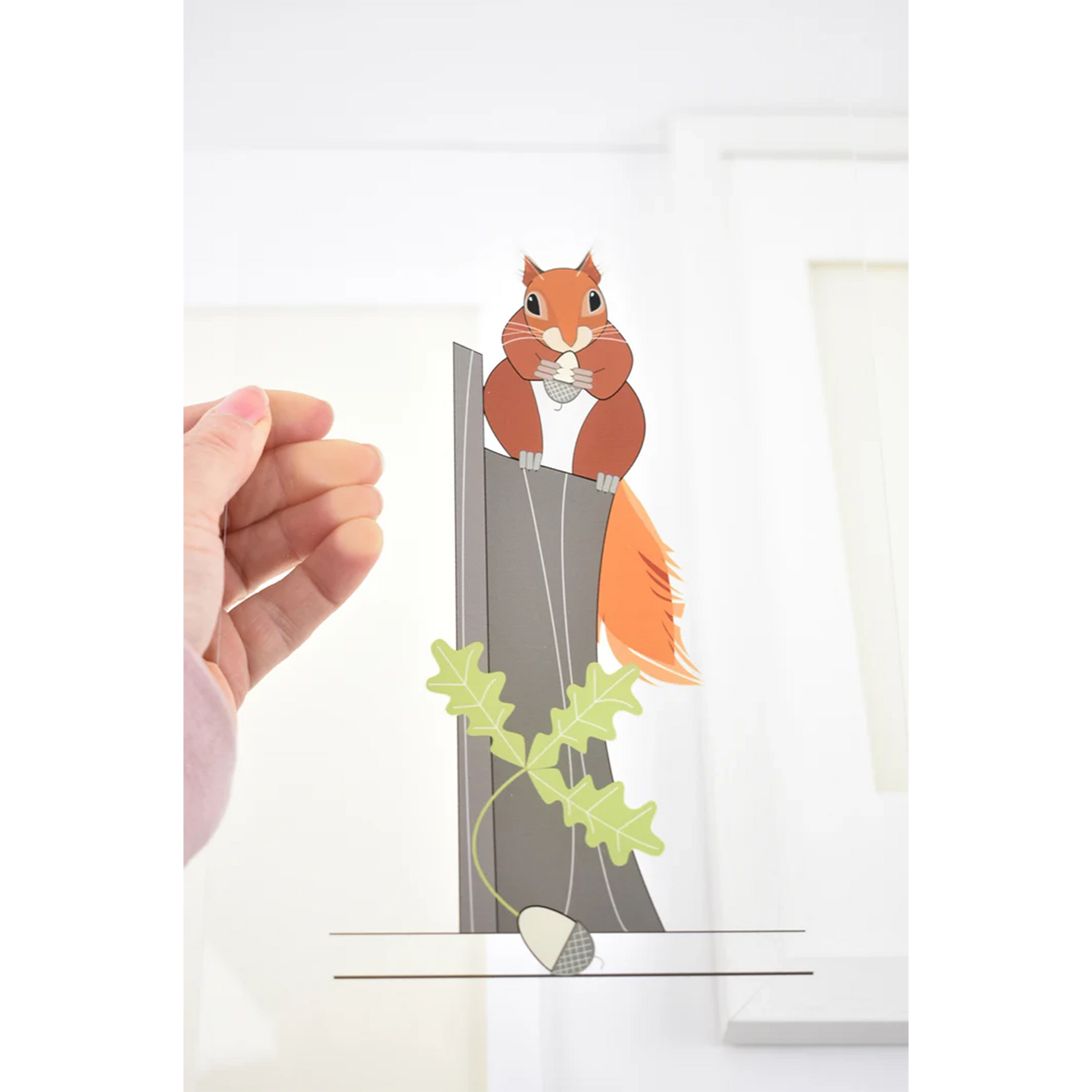 Rectangular acrylic artwork sheet of a red squirrel on a stump eating and acorn