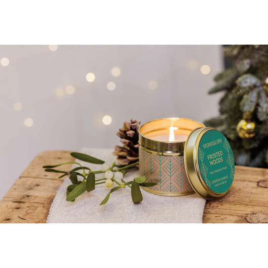 A gold tine candle with scandi style green pattern on brown paper in the scene 'Festive Wishes' - Lifestyle