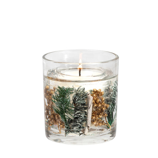 A tumbler candle with seasonal gold berries and pine tips in a clear gel