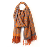 An orange and grey geometric diamond heart patterned scarf with tassel trim