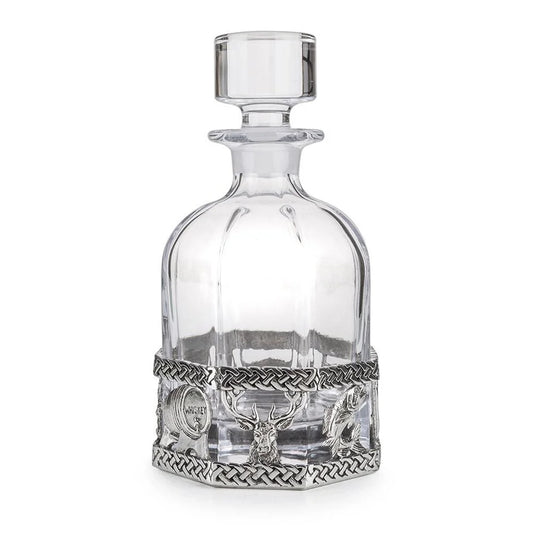 An octagonal glass decanter with pewter base decorated with Scottish Icons