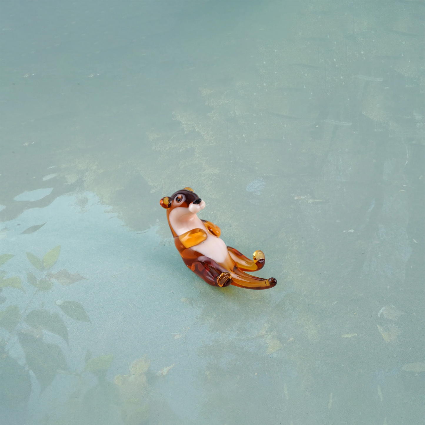 Swimming glass otter figurine