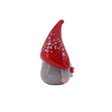 Small glass ornament of a gonk with braids, a red speckled hat and a grey dress back