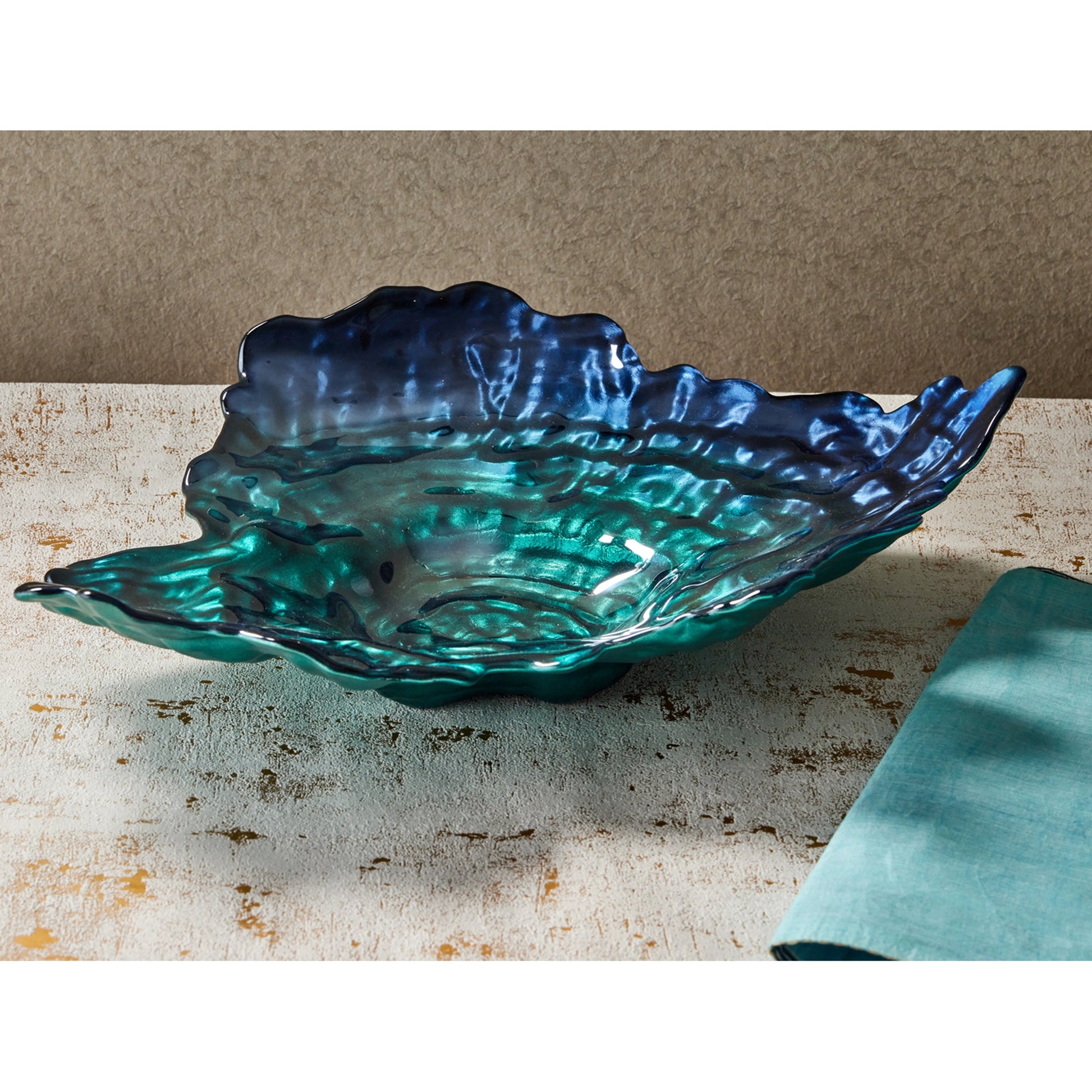 Decorative oyster shaped bowl with pearlescent turquoise and blue colours lifestyle