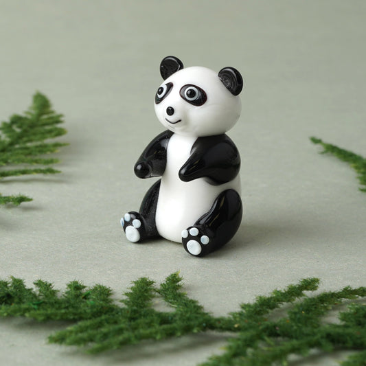 A glass black and white sitting panda charm lifestyle
