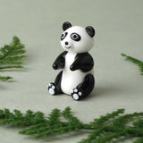 A glass black and white sitting panda charm lifestyle