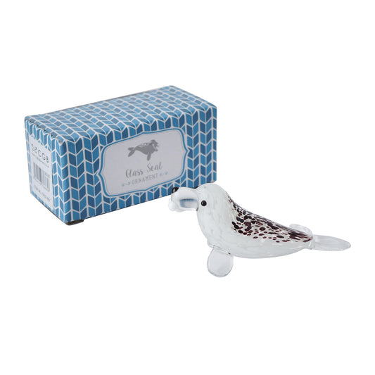 A speckled glass seal ornament with gift box