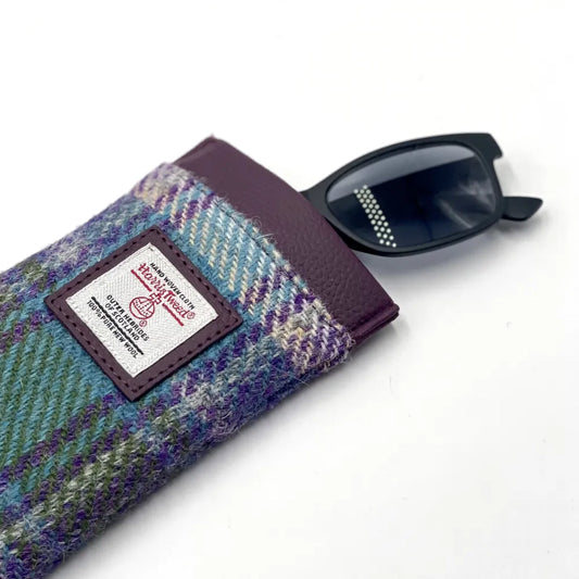 A Harris Tweed orb on glasses sleeve in purple, green and blue plaid