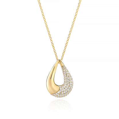 A curved teardrop shaped gold necklace half set with CZ stones
