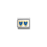 A Nomination link charm featuring gold double hearts in blue glitter