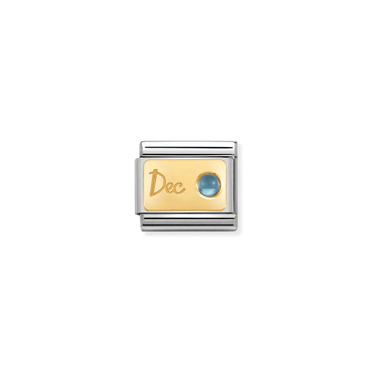 A Nomination charm link featuring a gold plaque engraved with 'Dec' and set with a round blue topaz stone