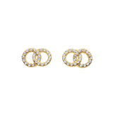 A pair of studs with double linked gold open circles set with cubic zirconia