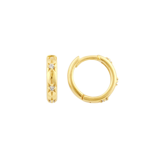 A pair of gold huggie hoop earrings with etched stars set with cubic zirconia stones