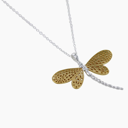 A silver pendant featuring a dragonfly with detailed gold filigree wings