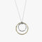 A necklace featuring a small silver hoop inside a larger gold hoop with irregular texturing