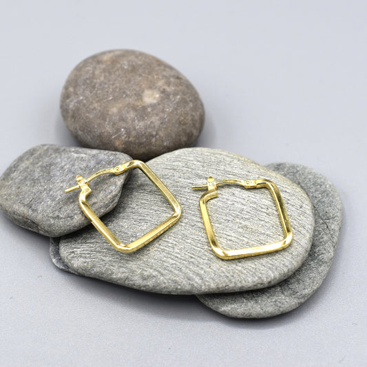 A pair of square shaped gold hoop earrings