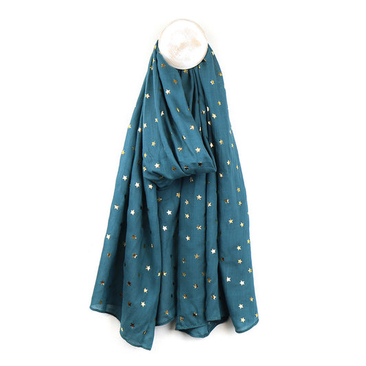 A teal blue scarf with gold foil star pattern