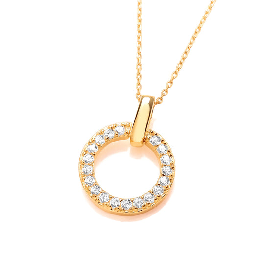 A gold pendant featuring an open circle set with white cubic zirconia stones and large bail
