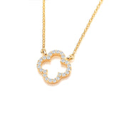 An open clover shaped gold necklace with cubic zirconia stones