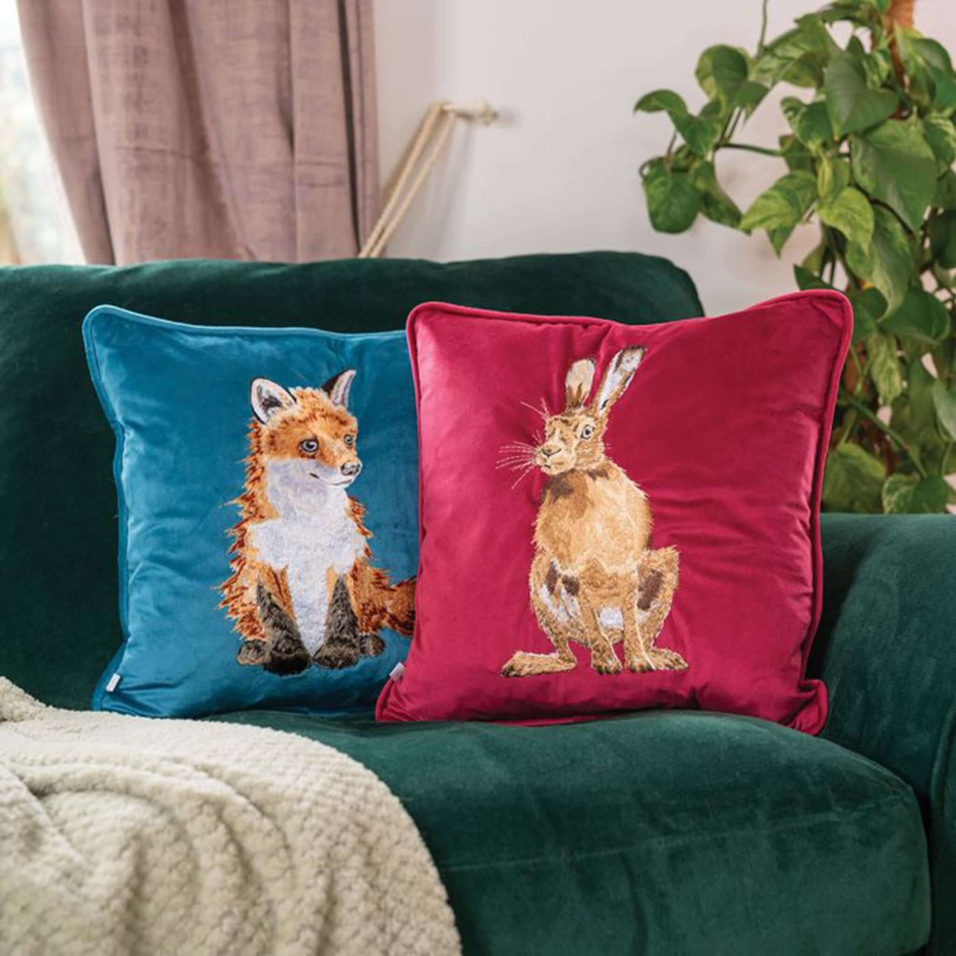Red faux suede cushion with embroidered hare design lifestyle