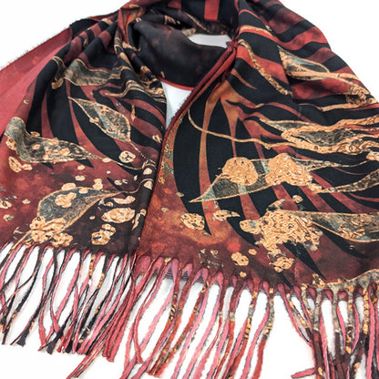 Detail of a red pashmina tassel scarf with black and gold foil leaf design