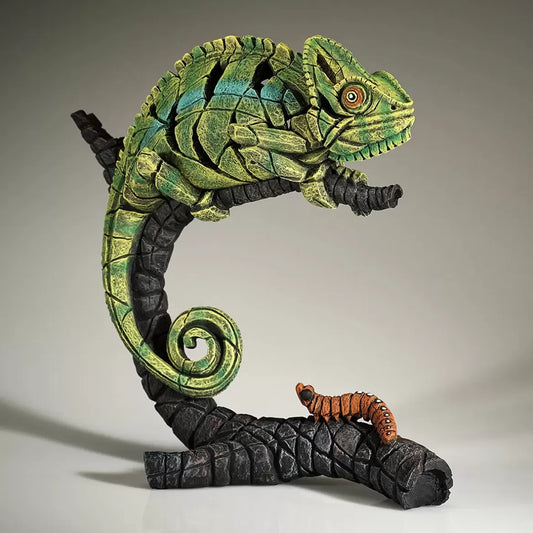 A textured and painted green chameleon on log sculpture