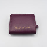 the back of a purple faux leather purse with the MACCESSORI logo in gold