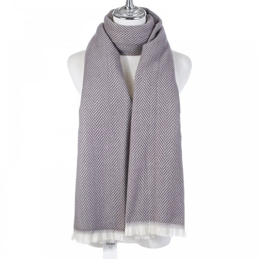 A grey chevron patterned scarf with a white fringe