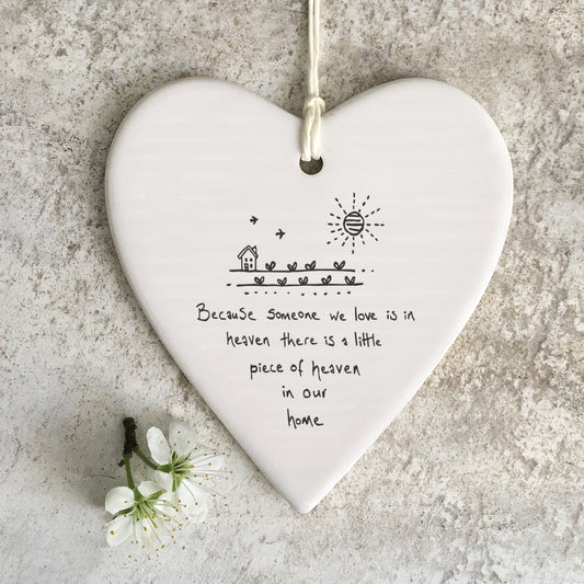 White ceramic heart with a house and farm illustration and a quote