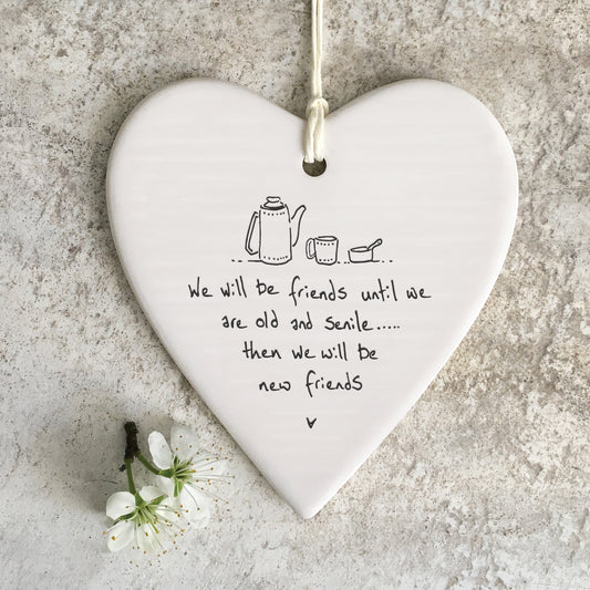 White ceramic heart with a tea pot and cup illustration and a quote