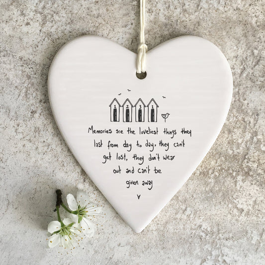 White ceramic heart with a beach shed illustration and a quote