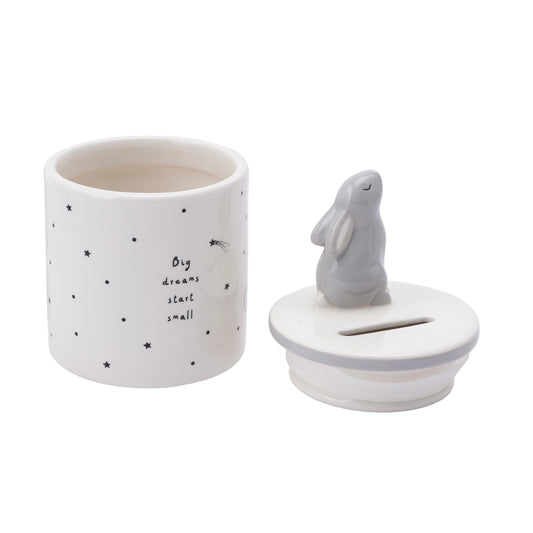 A ceramic cylinder money jar with a hare and a star design open