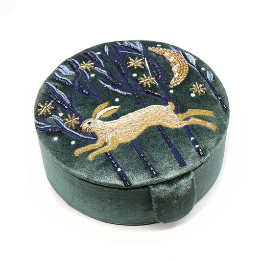 A round dark green velvet jewellery box with an embroidered and beaded Hare design