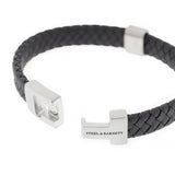 A braided black leather bracelet with stainless steel bar detail and chunky slider clasp