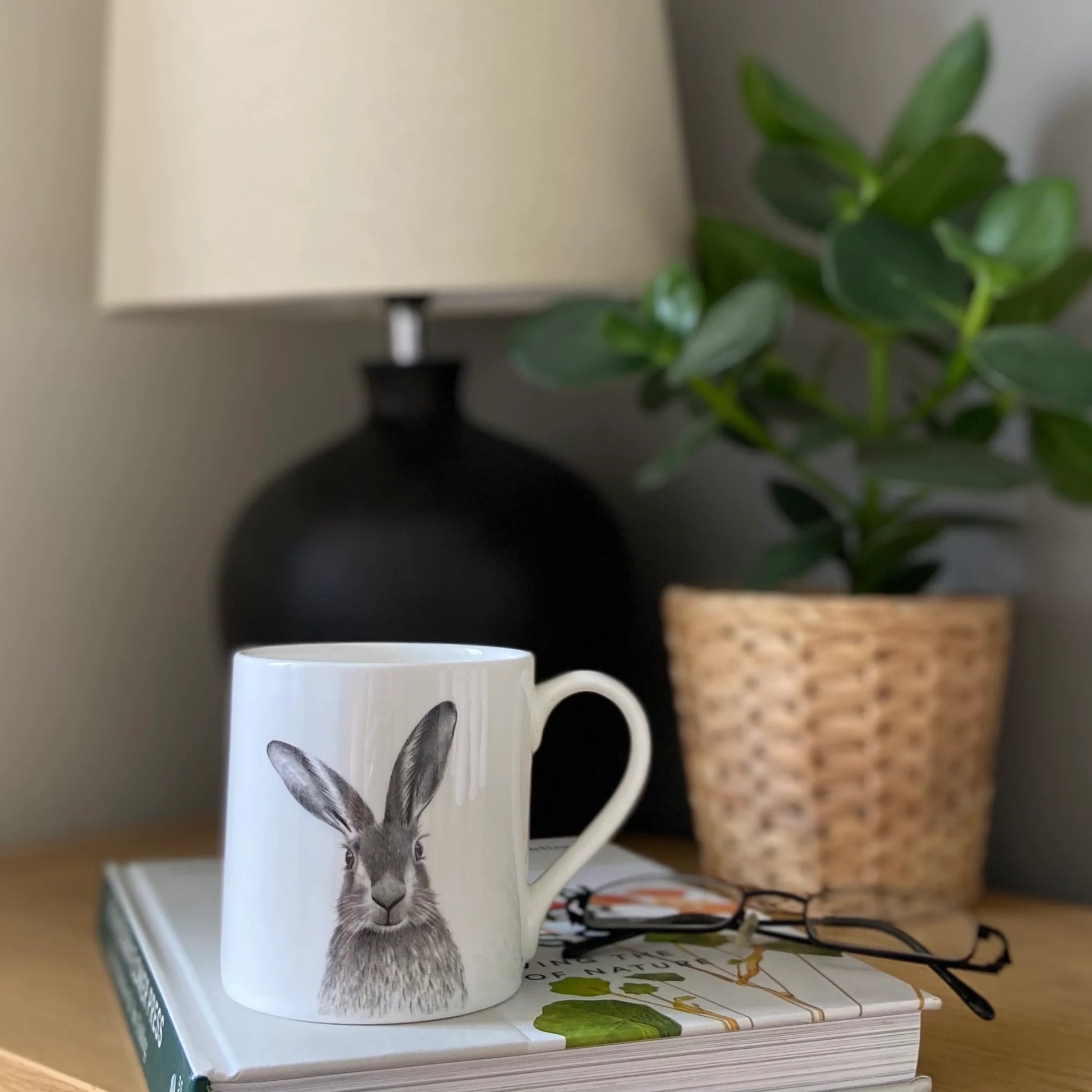 White mug with grey hare illustration - lifestyle