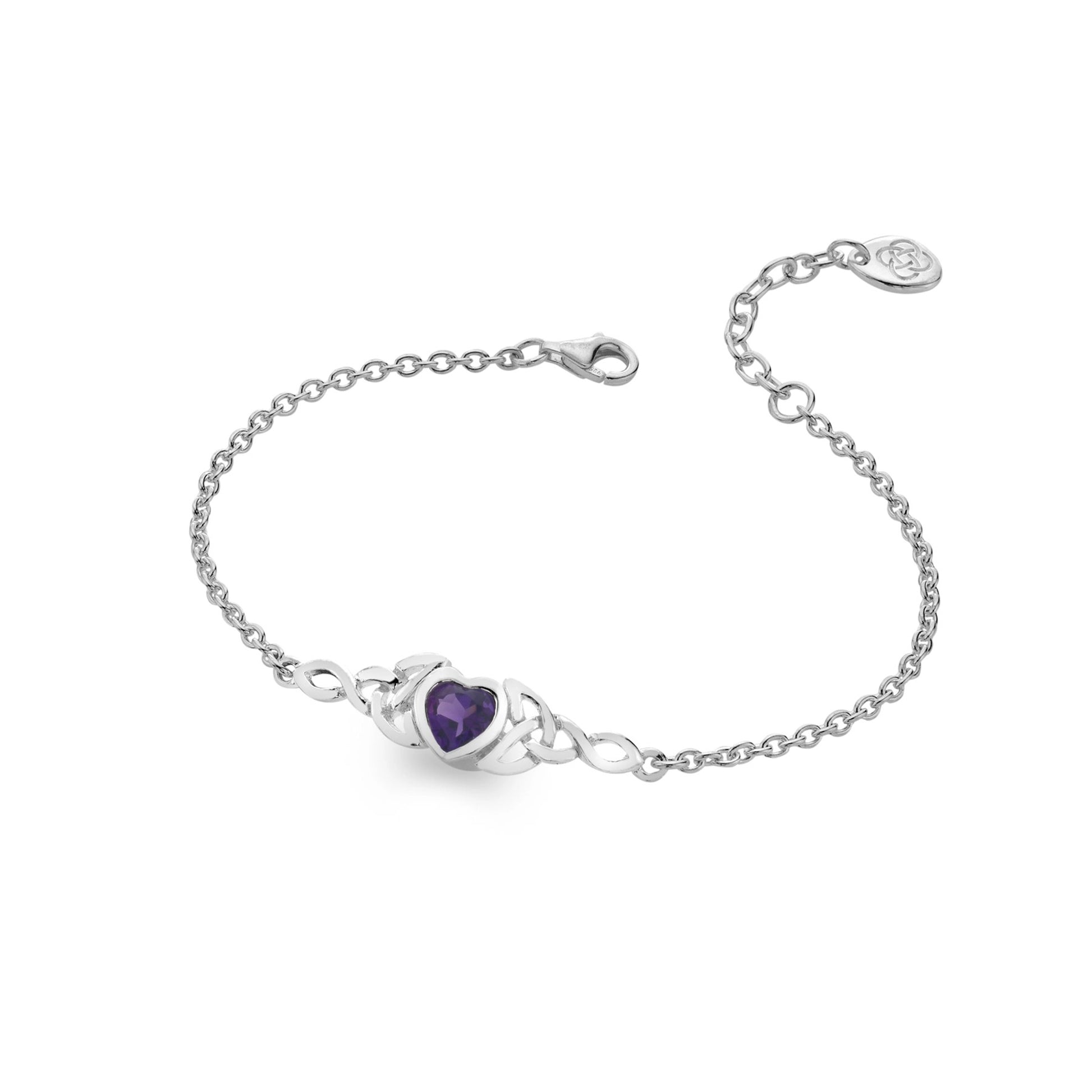 A silver chain bracelet with two trinity knots holding a faceted amethyst heart stone
