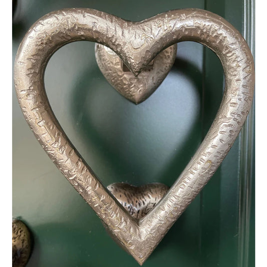 Heart shaped door knocker in satin silver with textured details