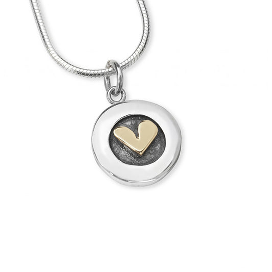 Simple round silver pendant with golden heart centre on silver snake chain