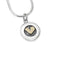 Simple round silver pendant with golden heart centre on silver snake chain