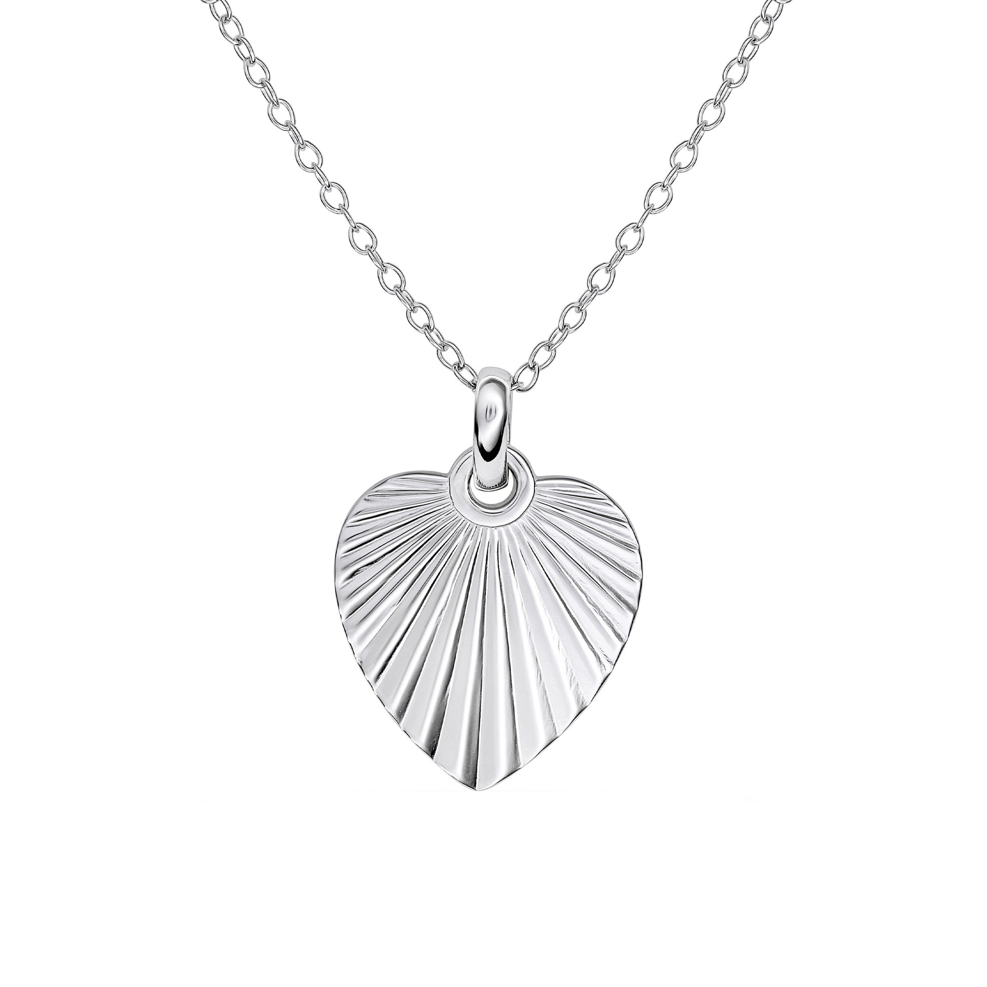 Silver heart shaped pendant engraved with a sunburst texture