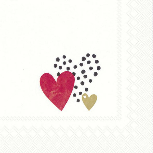 A white napkin featuring three hearts in red, gold and black polka dots