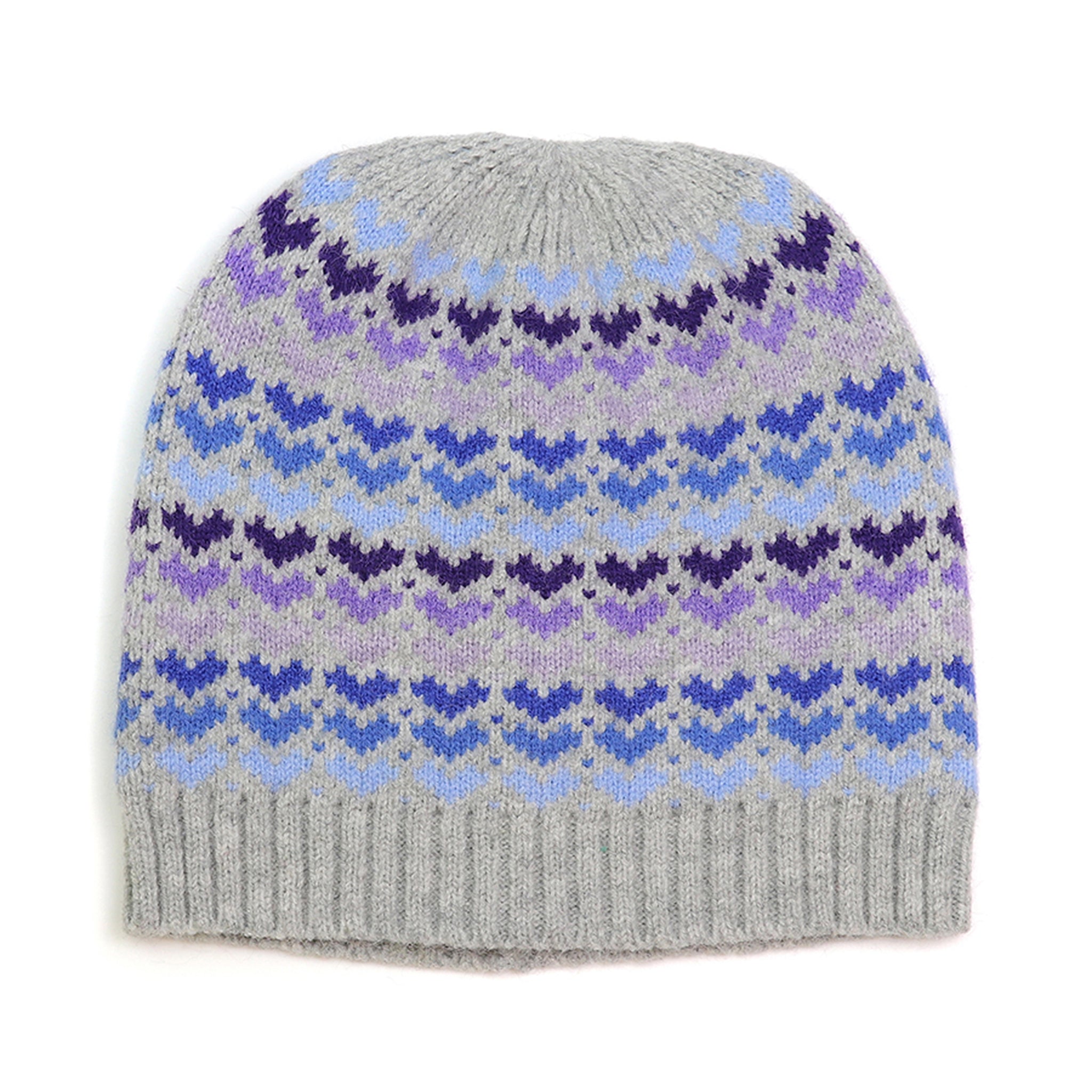 A grey knitted beanie hat with purple and blue hearts pattern