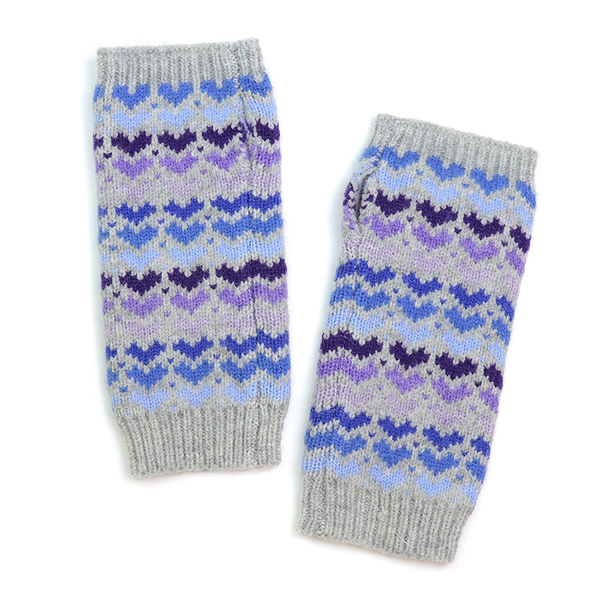 A pair of grey knitted wrist warmers with blue and purple repeat heart pattern