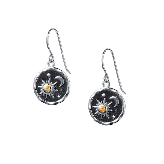 Round coin shaped drop earrings with black centres and a sun and moon motif set with an orange citrine stone