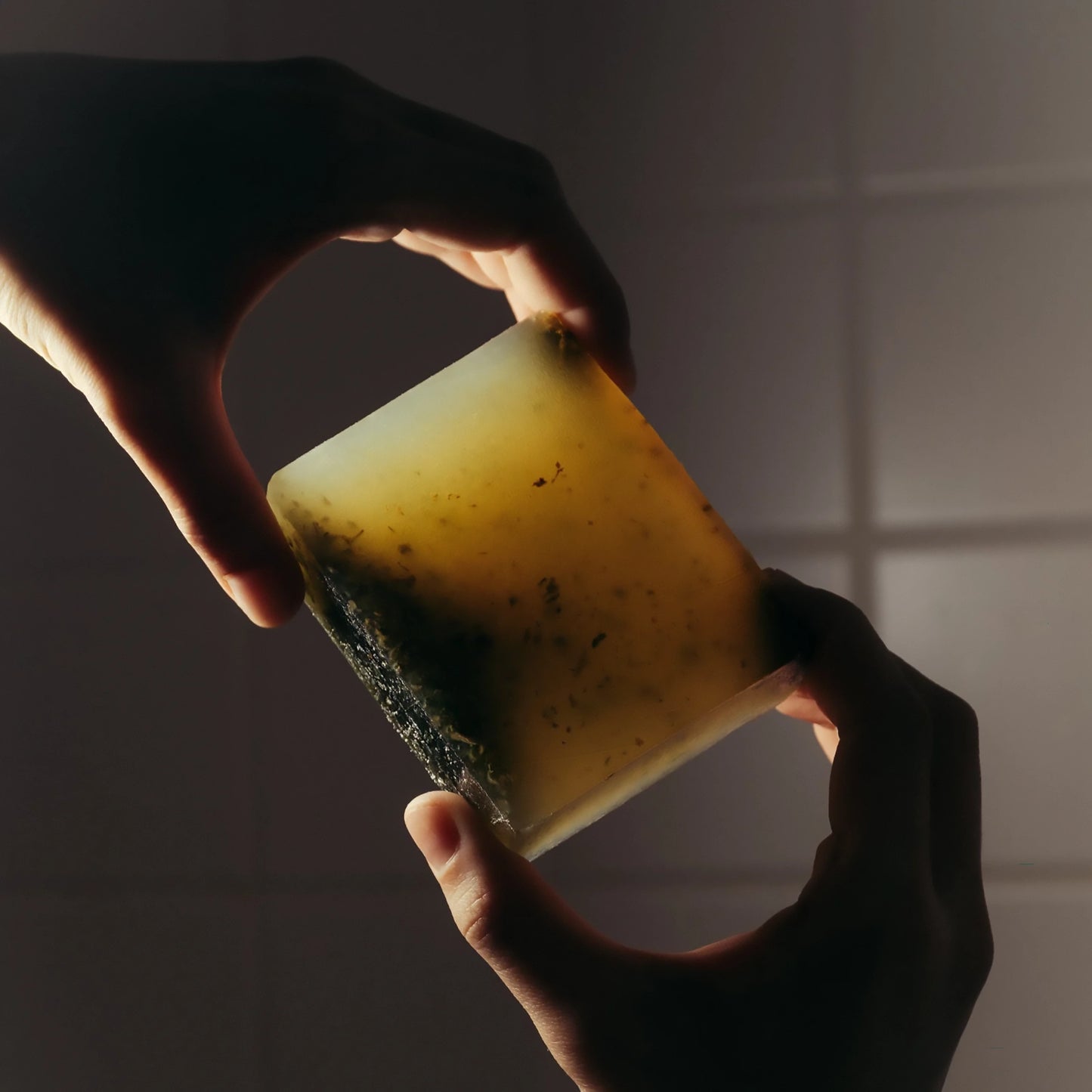 Highland Soap Co. bar of organic seaweed soap being held to show inclusions